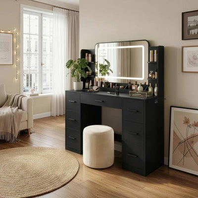 Black Treevan Aura Studio Vanity set with LED mirror placed in a modern bedroom setting.