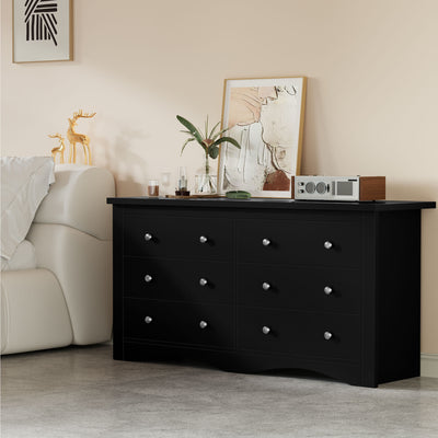 Black Treevan Hestia 6-drawer double dresser styled in a cozy living room space with modern decor.