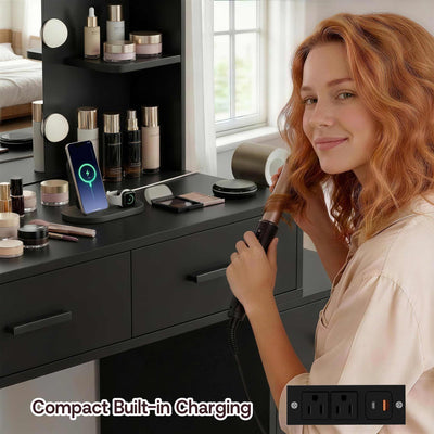 Woman styling hair at Black Treevan Muse Suite Vanity desk featuring built-in power outlets and USB ports.