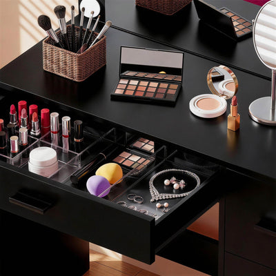 Close-up view of Black Treevan Muse Tower Vanity drawer storage space organized with cosmetics.
